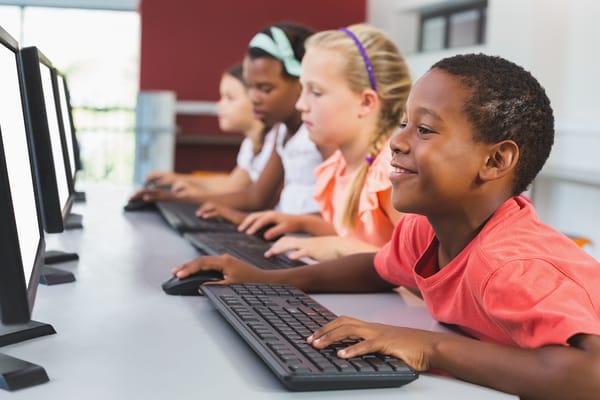 High school students learning to code in a classroom
